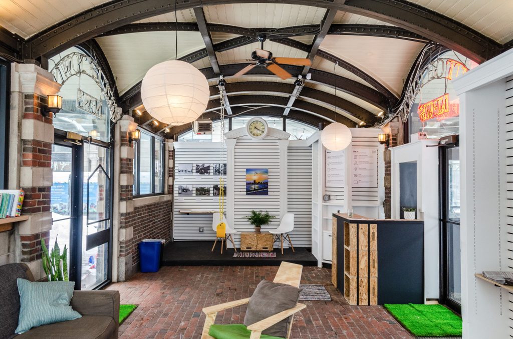 An image of the CultureHouse Harvard with lights above a seating area and desk