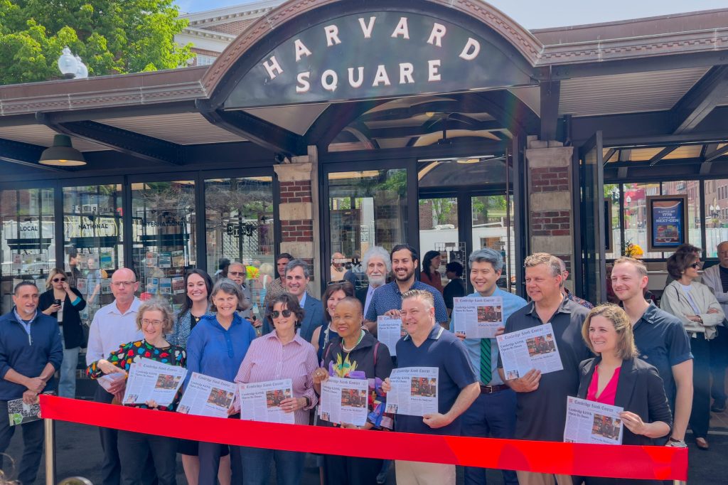 City officials and project partners stand in front of the KiOSK on opening day, about to cut the ribbon.