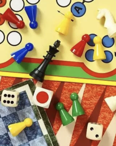 dice, board game, and chess pieces all laying on different playing boards