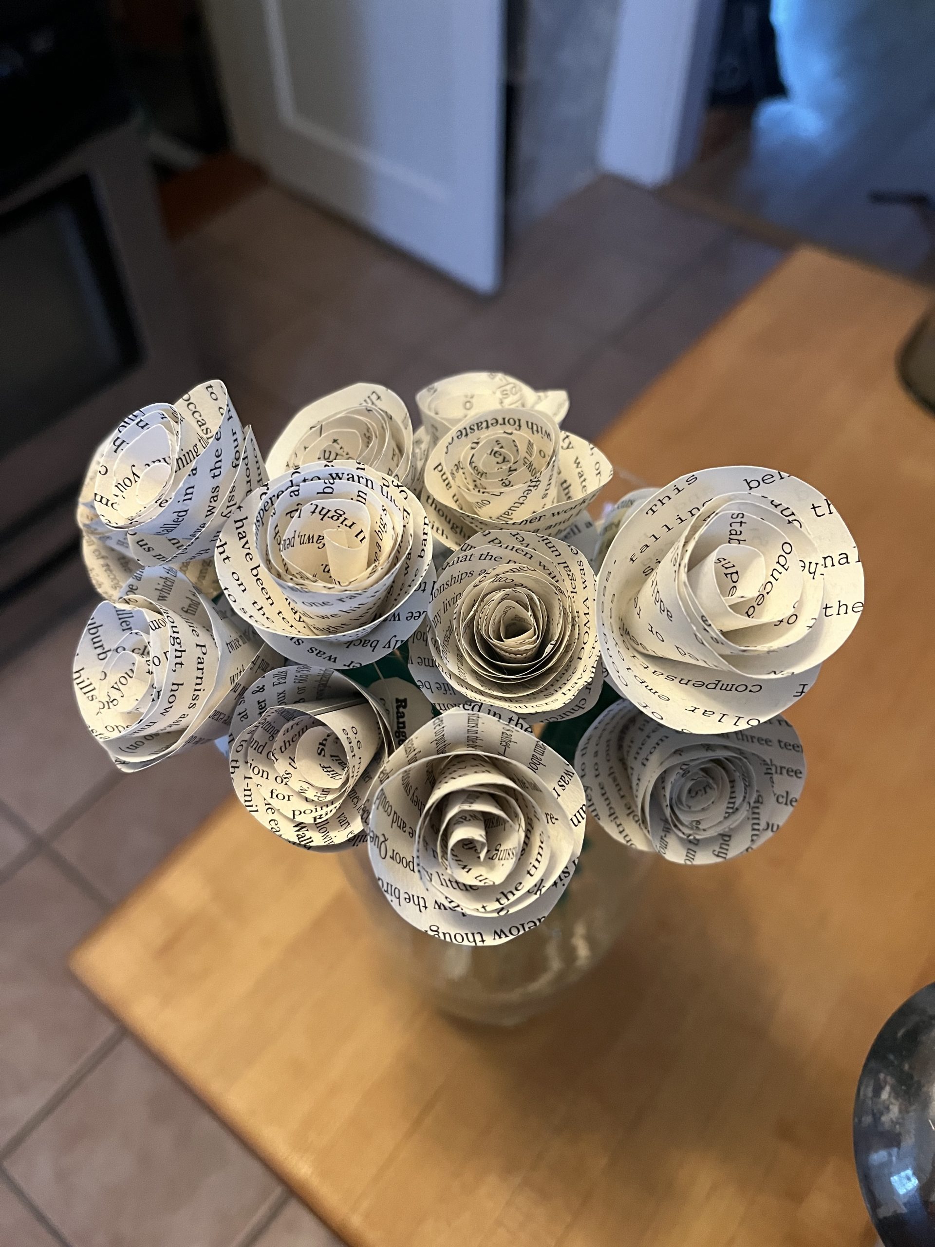 A bird's-eye view of a bouquet of paper flowers on top of a wooden surface
