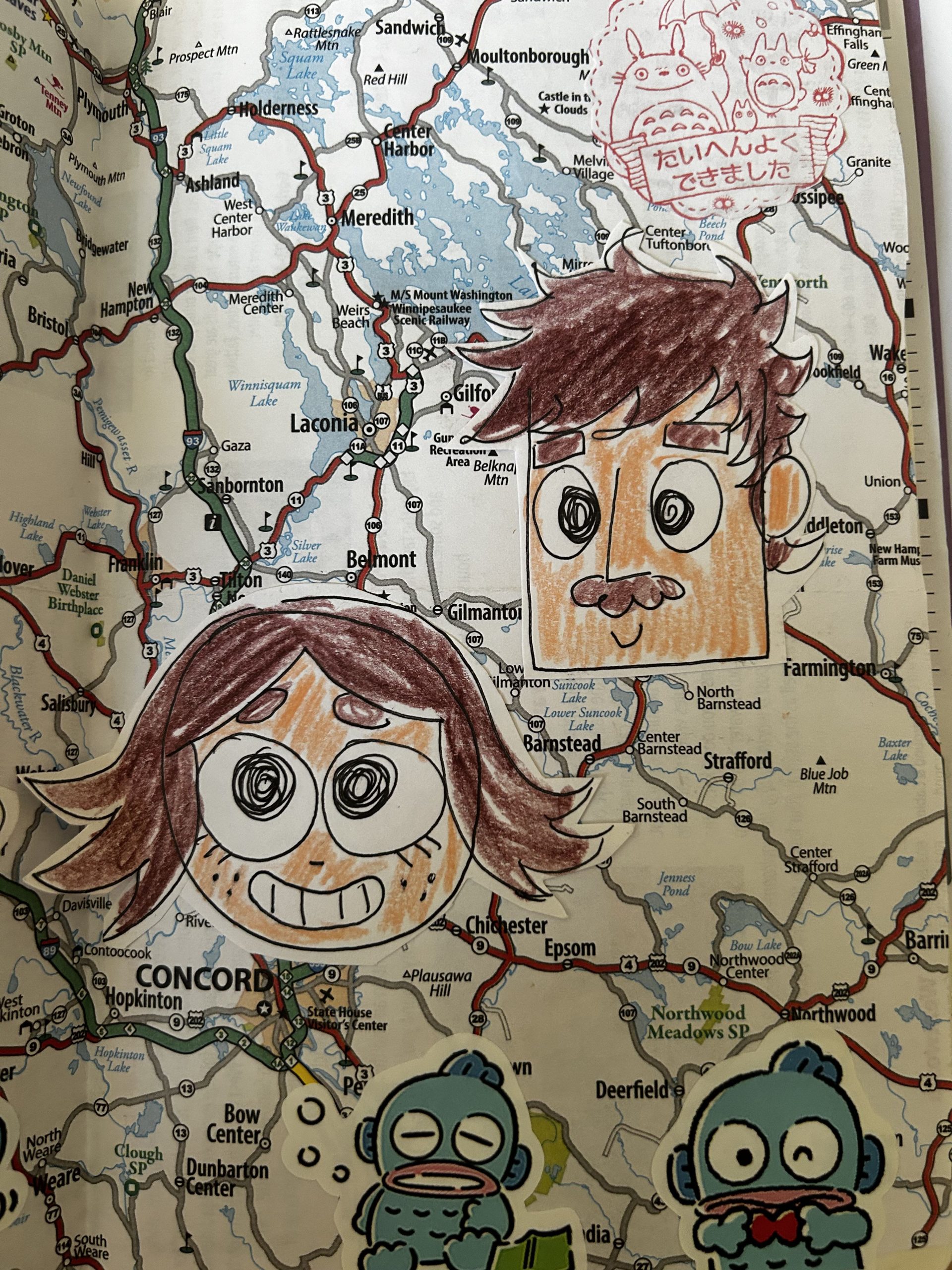 Image features two disembodied cartoon heads and two kappa on top of a road map